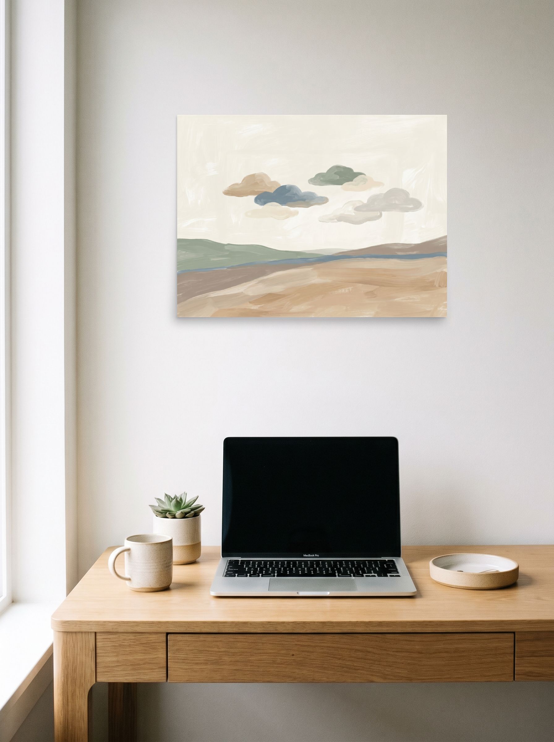 A 24x18 inch unframed paper Minimalism print of 'Whispering Horizons' hanging above a worktable with a laptop.