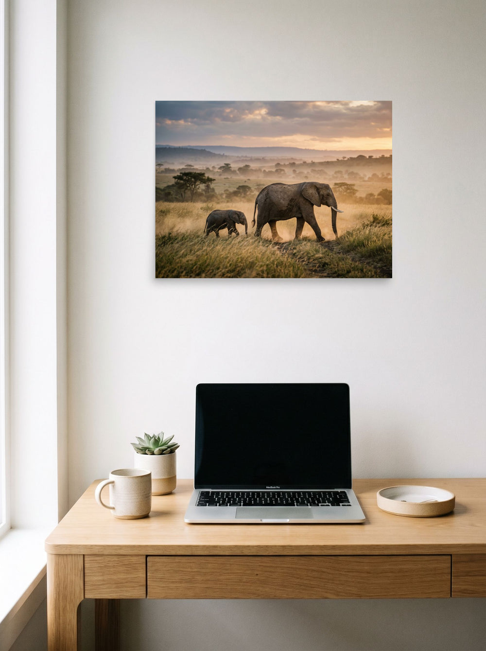 A 24x18 inch unframed paper Art photography print of 'Savannah Stroll' hanging above a worktable with a laptop.