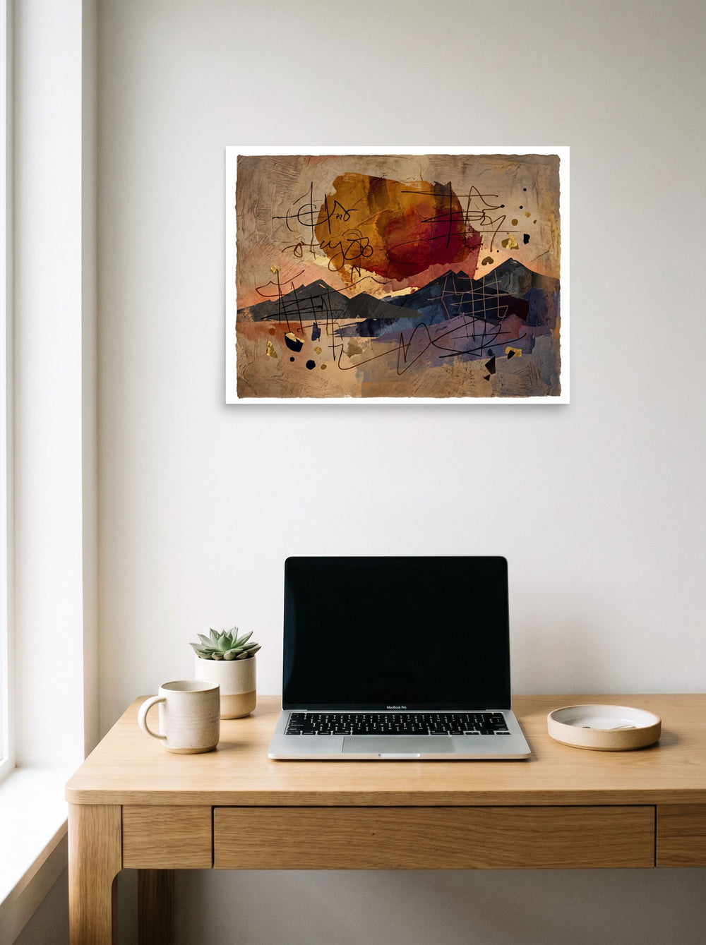 A 24x18 inch unframed paper Dau-al-Set print of 'Calligraphic Horizon', displayed over a compact desk setup.