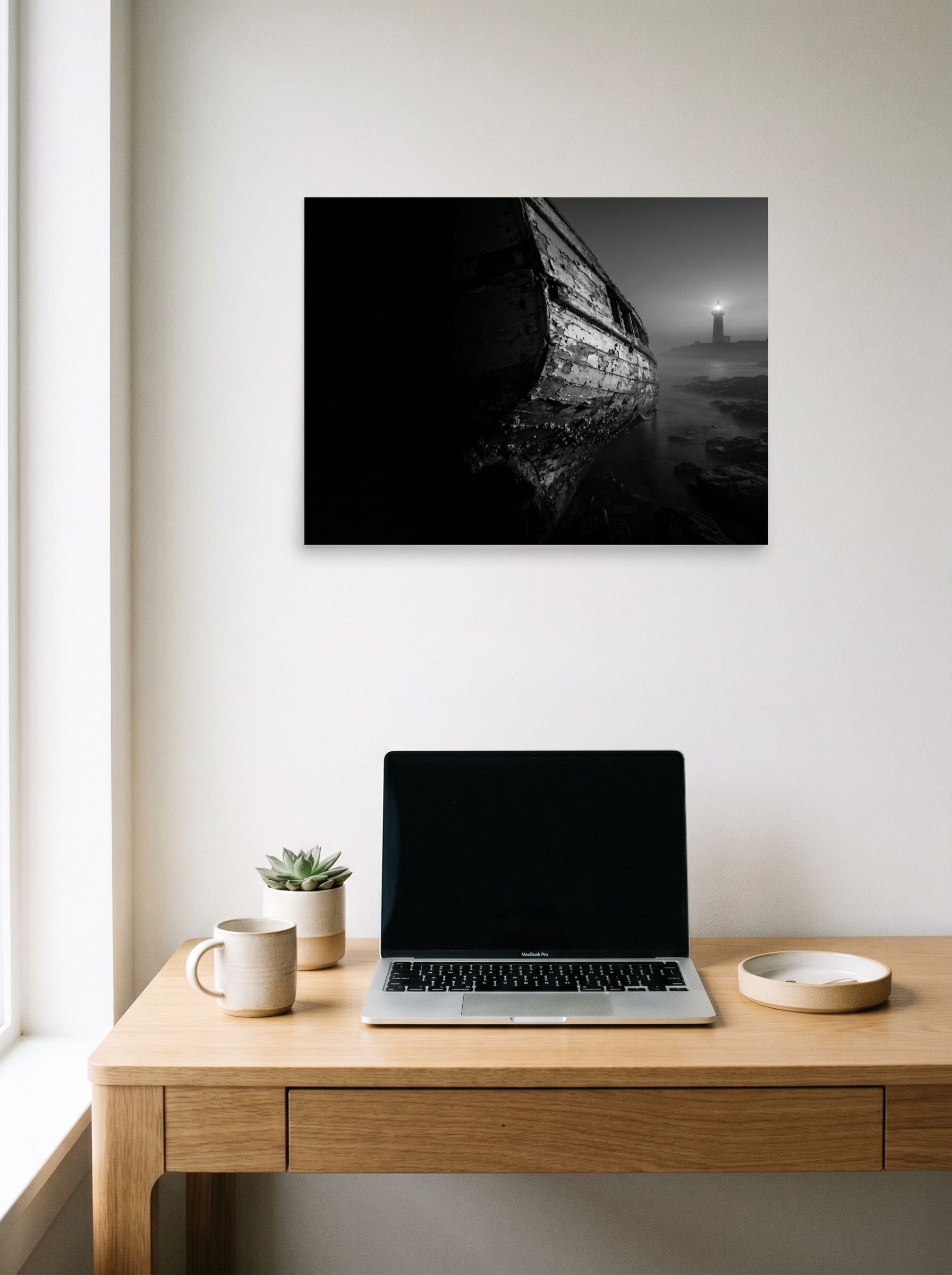 A 24x18 inch unframed paper Art photography print of 'Final Anchor' hanging above a worktable with a laptop.