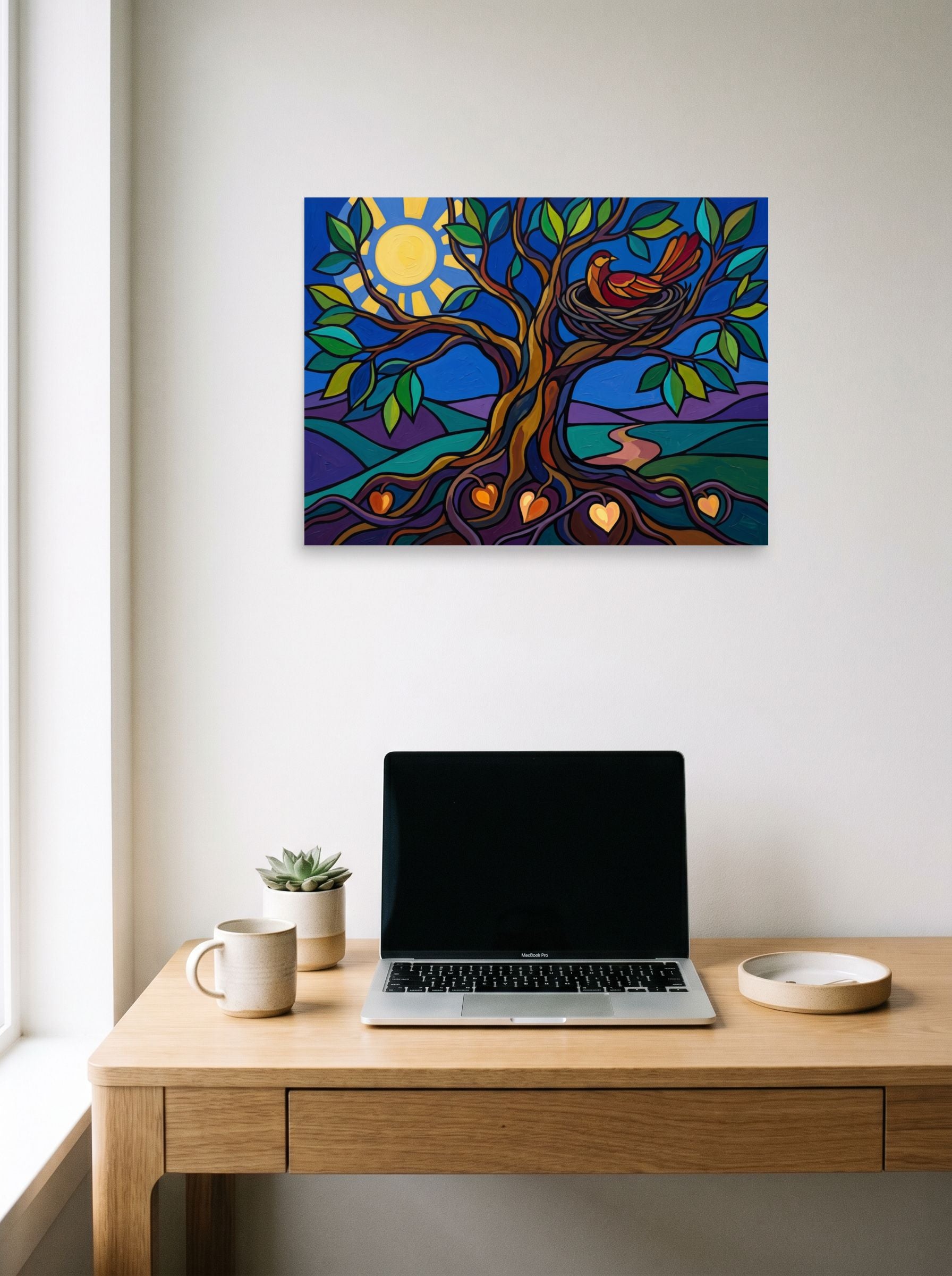 A 24x18 inch unframed paper Cloisonnism print of 'The Tree of Nurture' hanging above a worktable with a laptop.