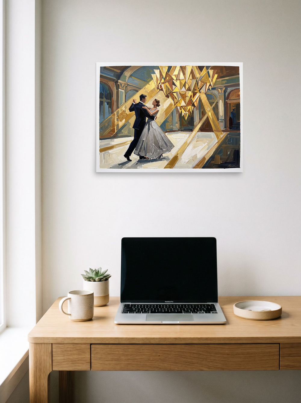 A 24x18 inch unframed paper Art Deco print of 'The Midnight Waltz' hanging above a worktable with a laptop.