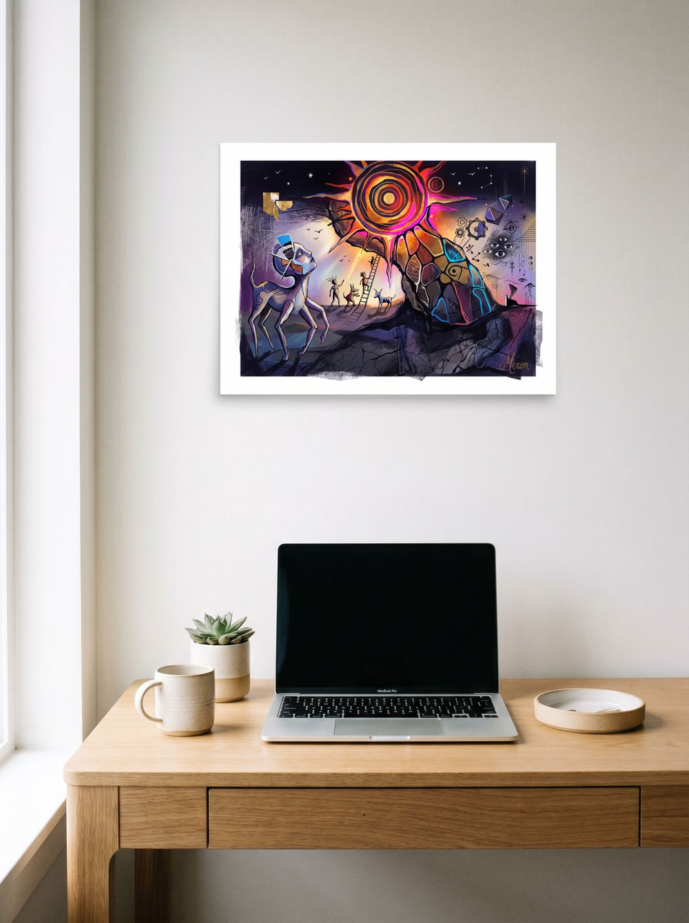 'The Concentric Sun' in 24x18 inch unframed paper, hanging above a worktable with a laptop.