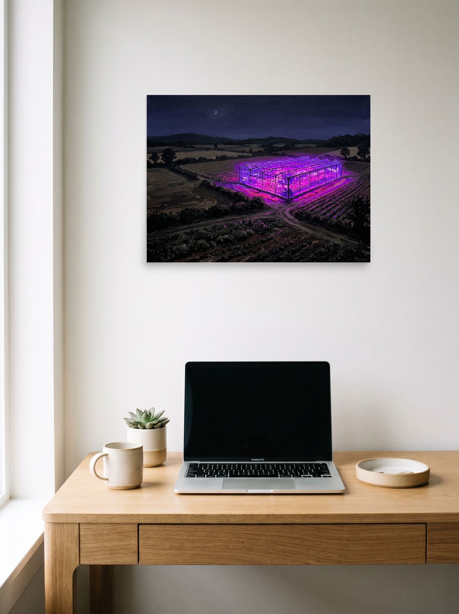 A 24x18 inch unframed paper Magic realism,Impressionism print of 'Midnight Purple Harvest' hanging above a worktable with a laptop.