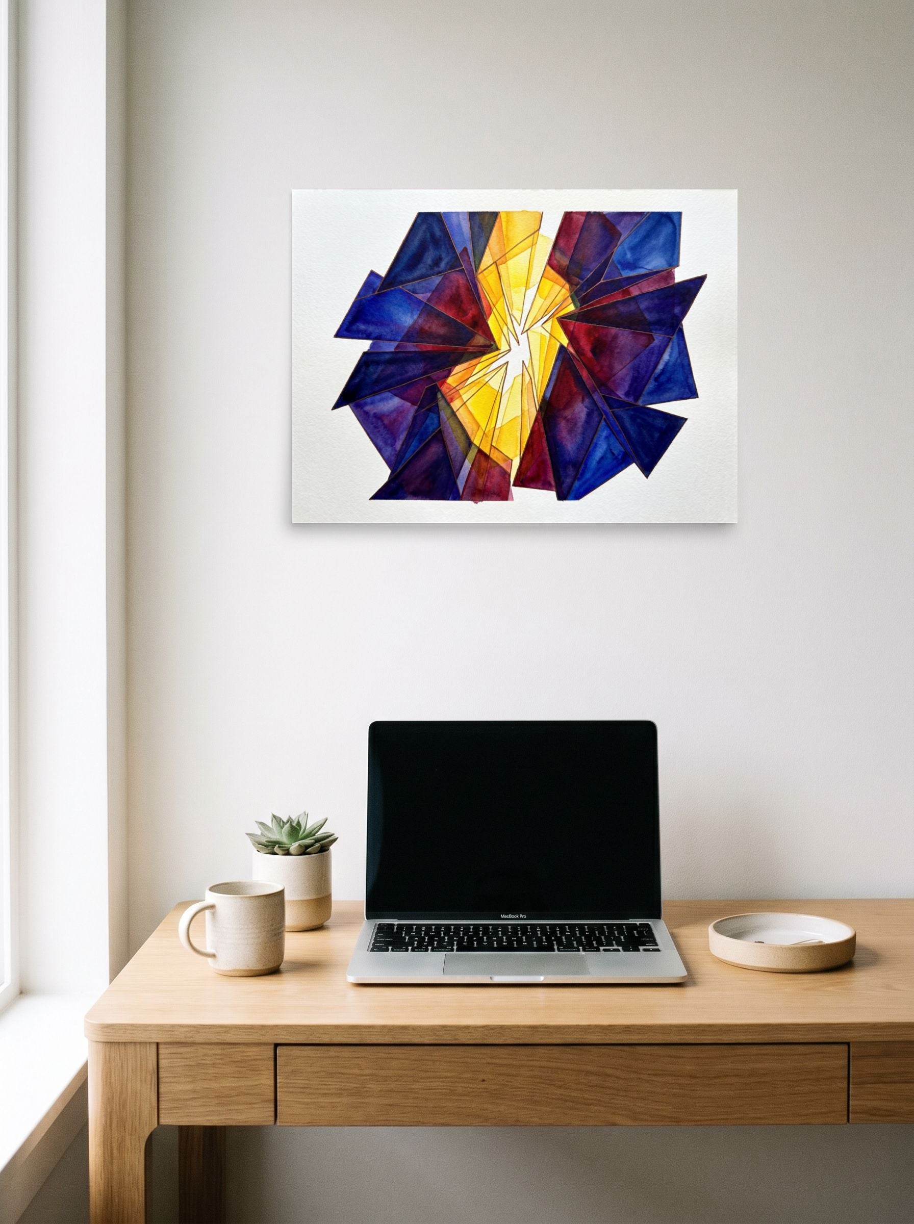 A 24x18 inch unframed paper Abstract art print of 'The Long Hour' hanging above a worktable with a laptop.