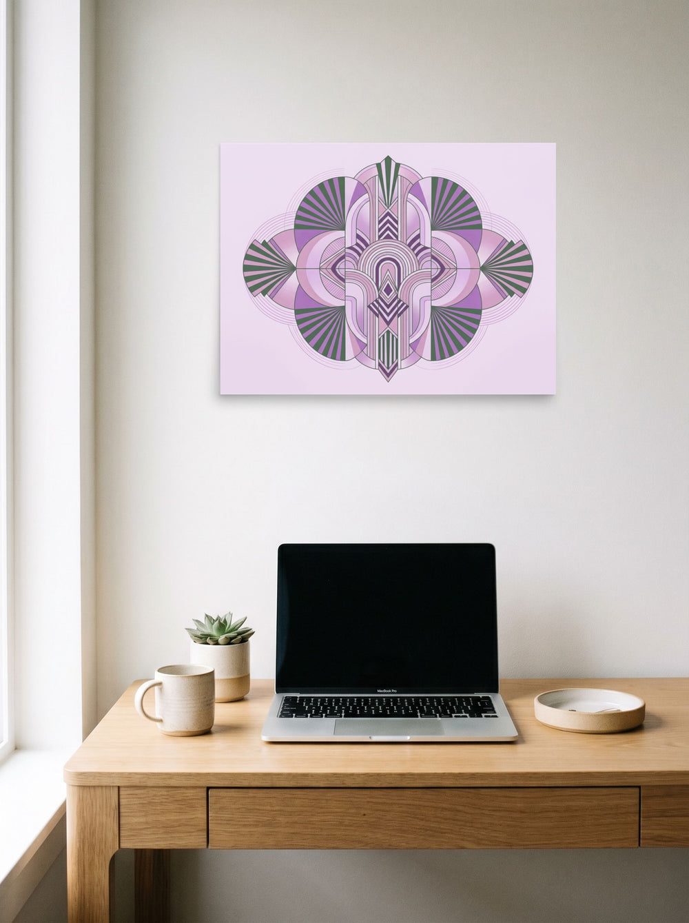 A 24x18 inch unframed paper Art Deco print of 'Lavender Deco Symmetry' hanging above a worktable with a laptop.