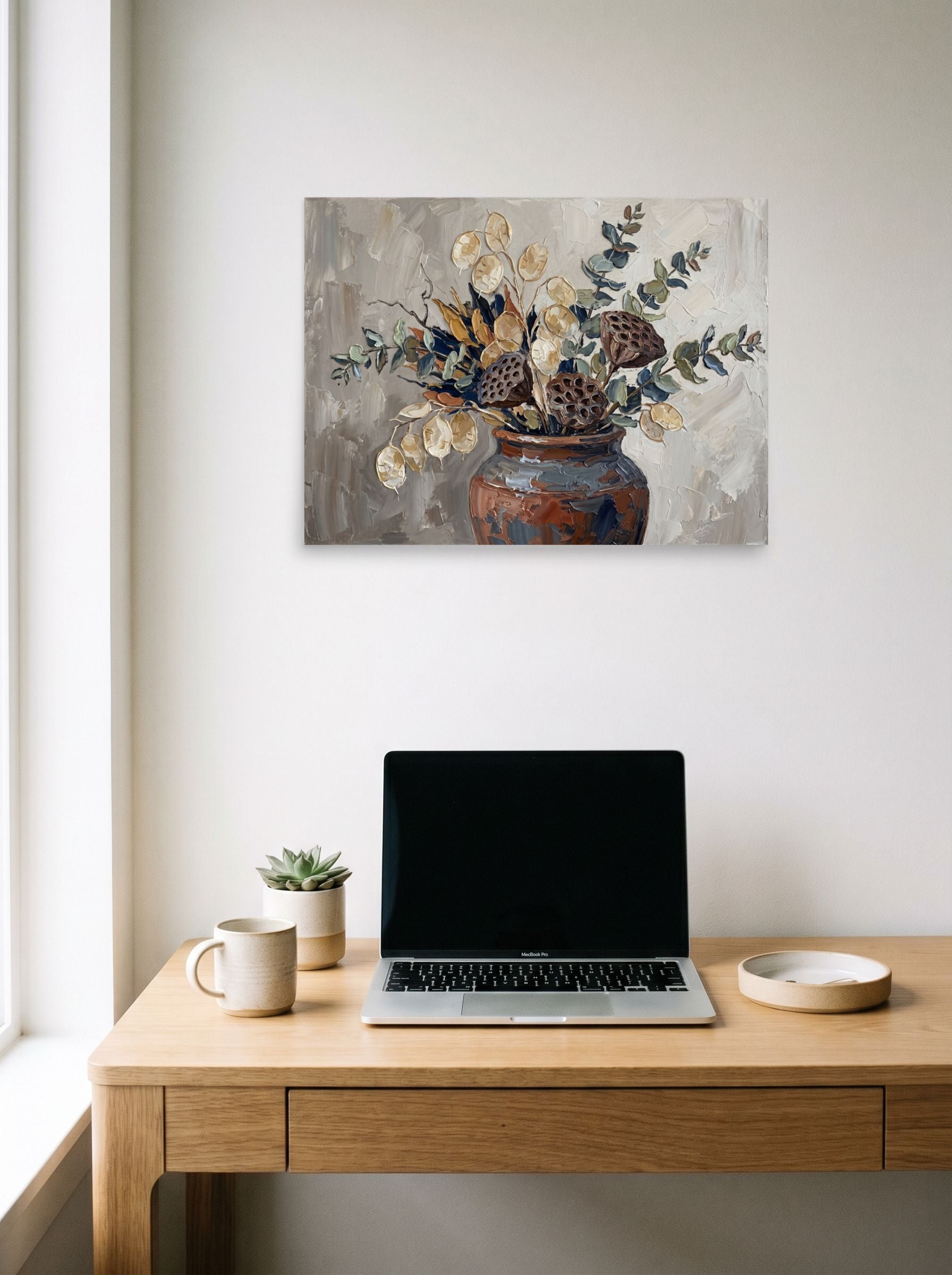 A 24x18 inch unframed paper Expressionism print of 'Earthy Blooms in Clay' hanging above a worktable with a laptop.