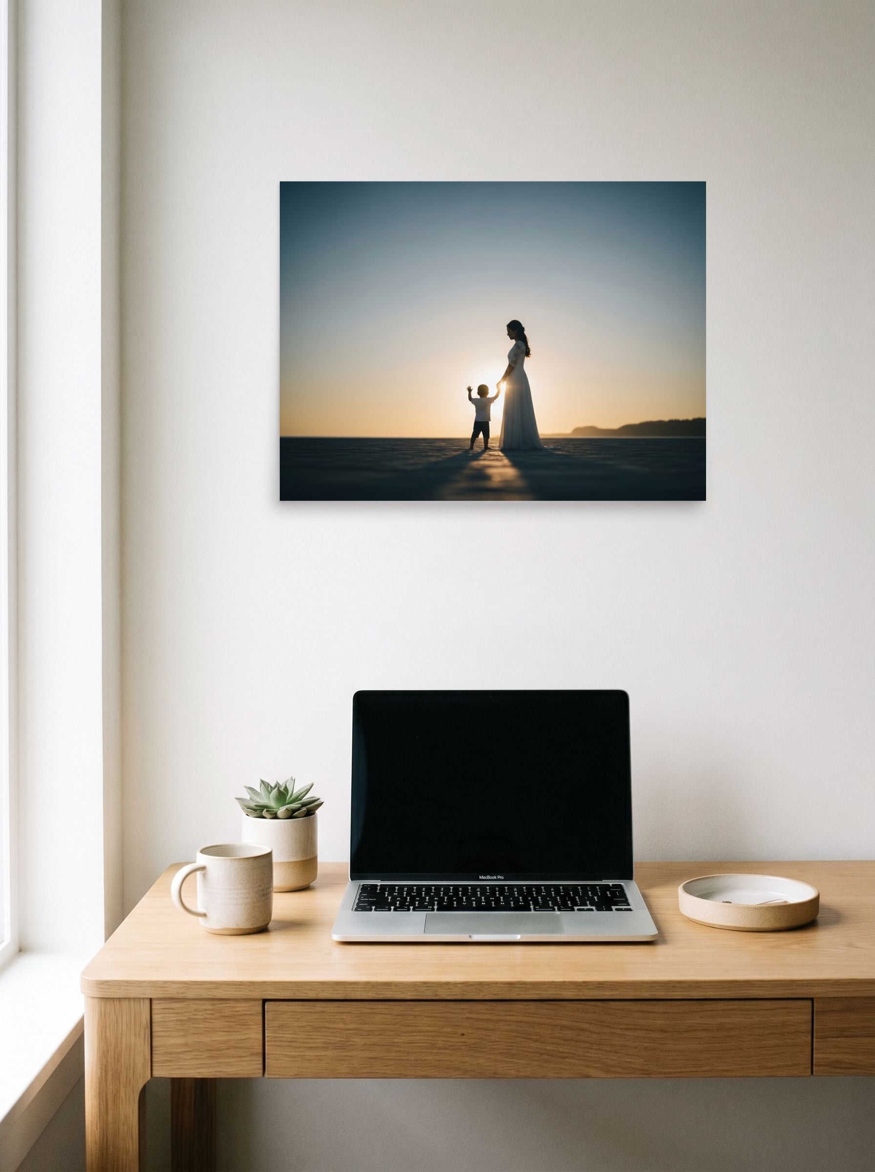 A 24x18 inch unframed paper Art photography print of 'Sunset Bond' hanging above a worktable with a laptop.