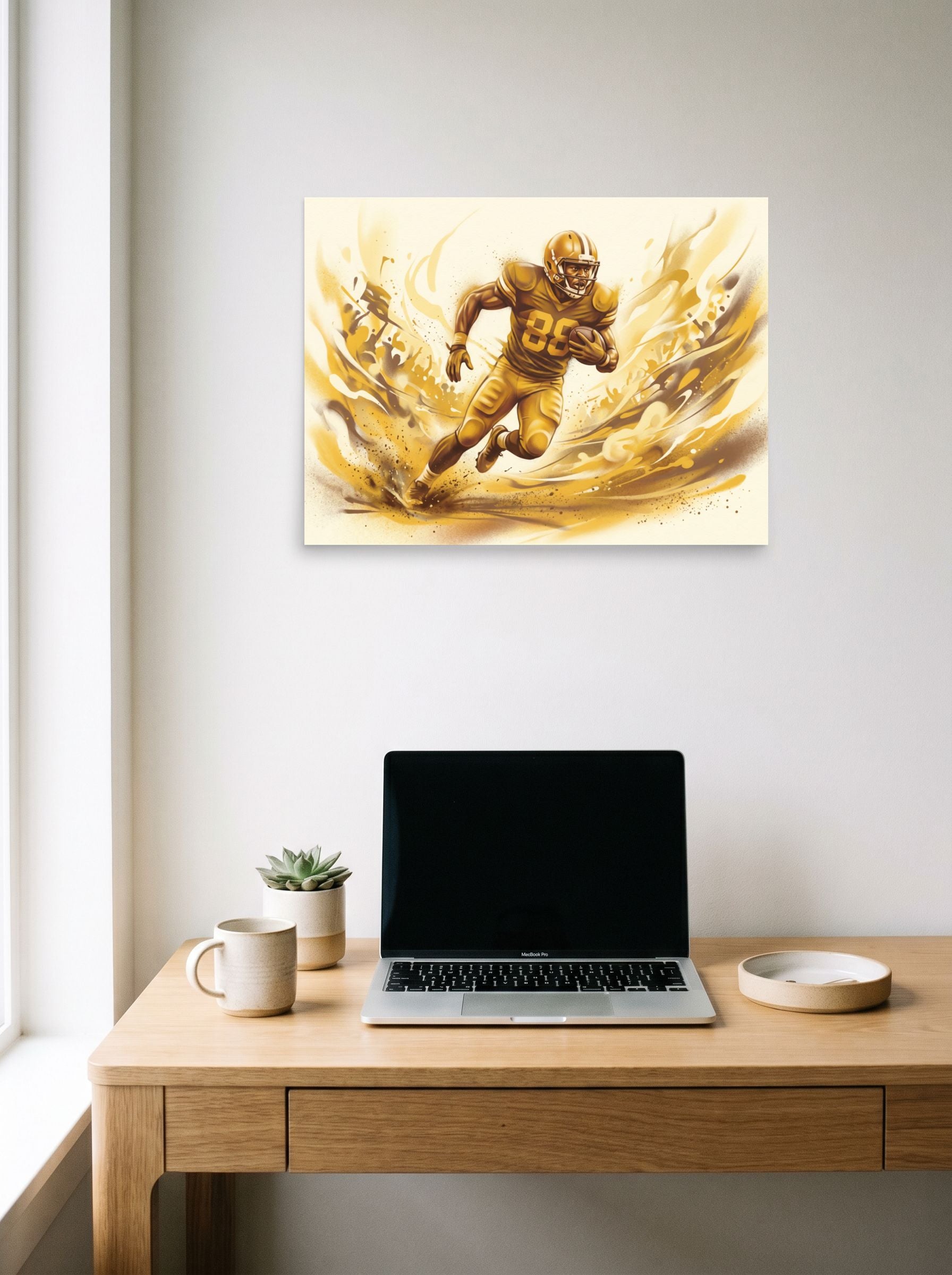 A 24x18 inch unframed paper Figurative art print of 'Golden Gridiron' hanging above a worktable with a laptop.