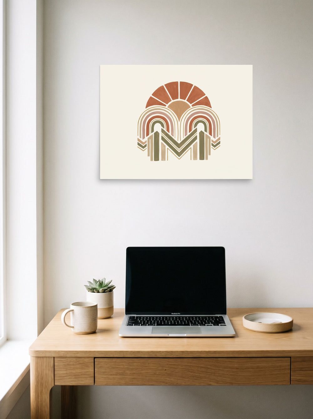 A 24x18 inch unframed paper Geometric abstract art print of 'Earthy Arches' hanging above a worktable with a laptop.