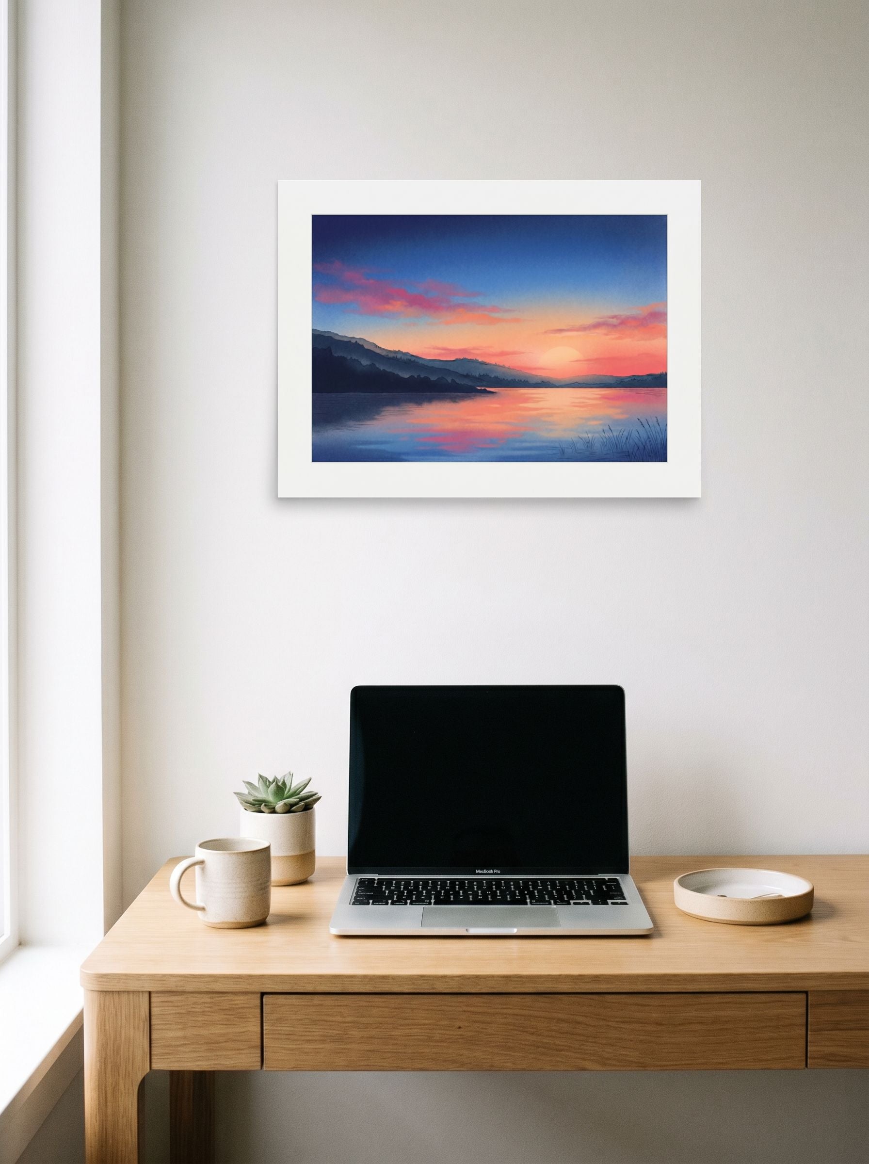 A 24x18 inch unframed paper Impressionism,Romanticism print of 'Twilight on the Lake' hanging above a worktable with a laptop.