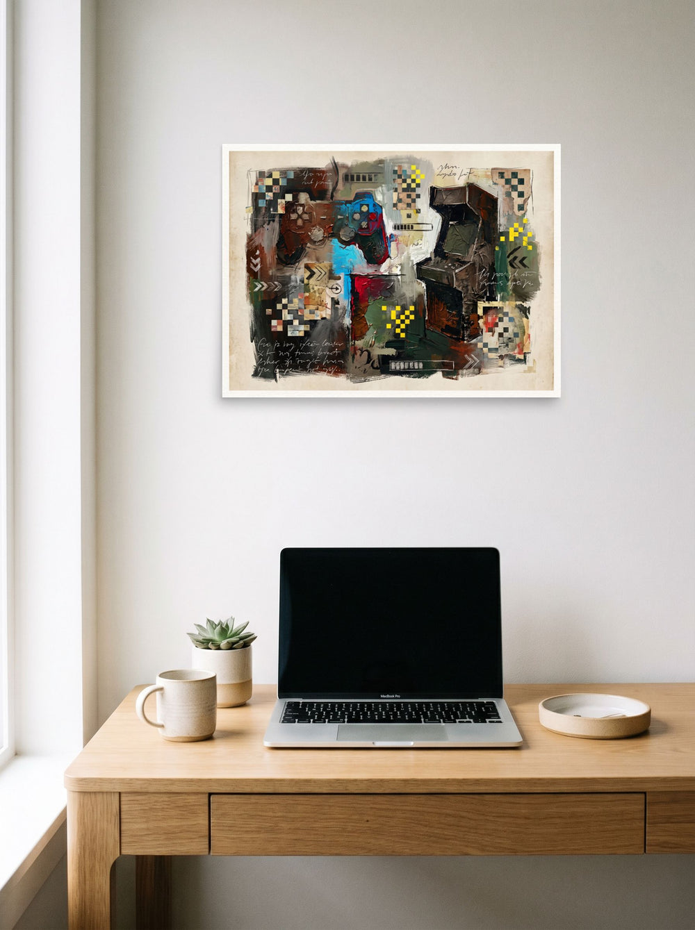 Dau-al-Set wall art 'Arcade Relic', unframed paper at 24x18 inch, hanging above a worktable with a laptop.