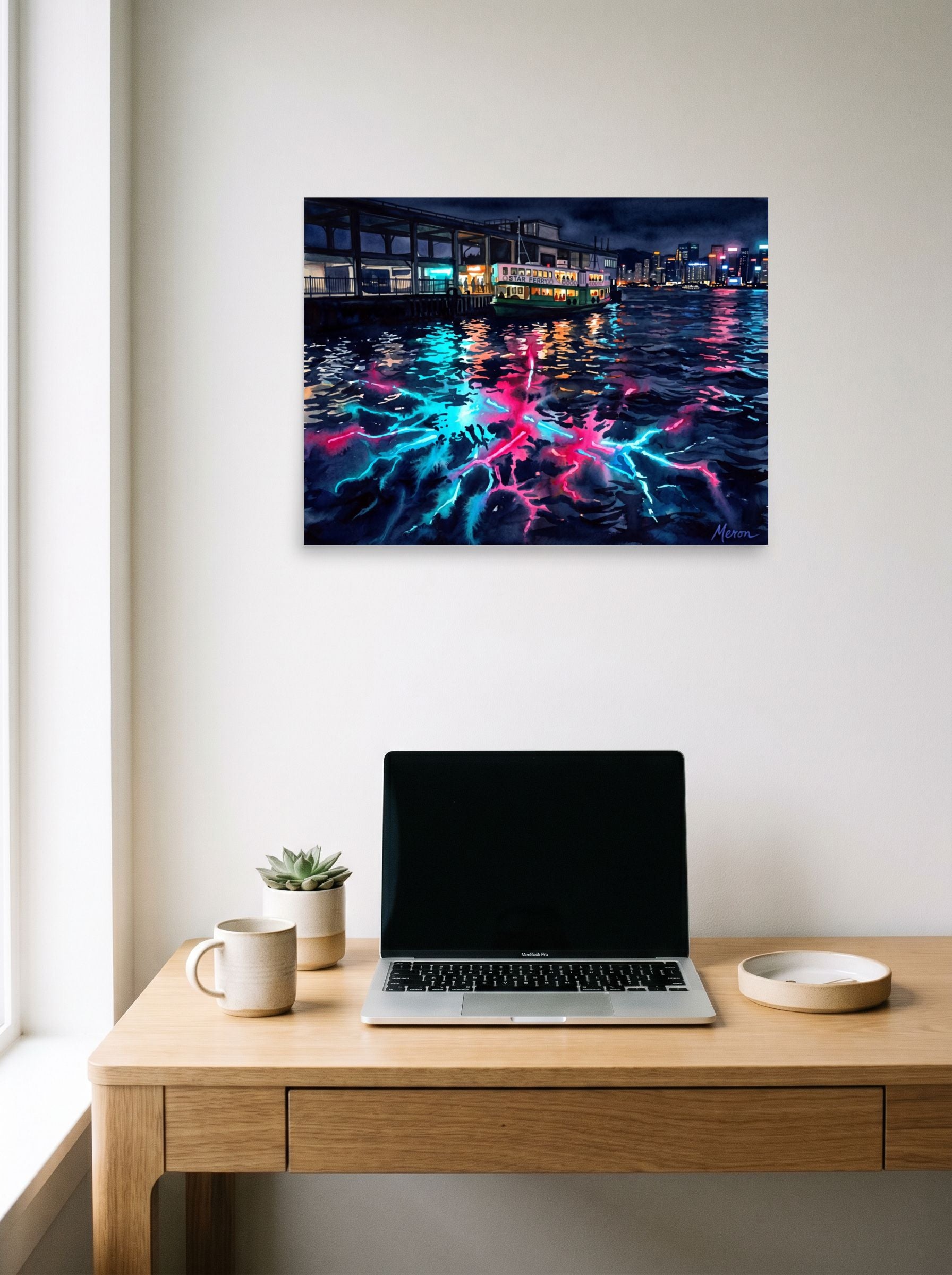 A 24x18 inch unframed paper Impressionism print of 'Star Ferry Serenity' hanging above a worktable with a laptop.