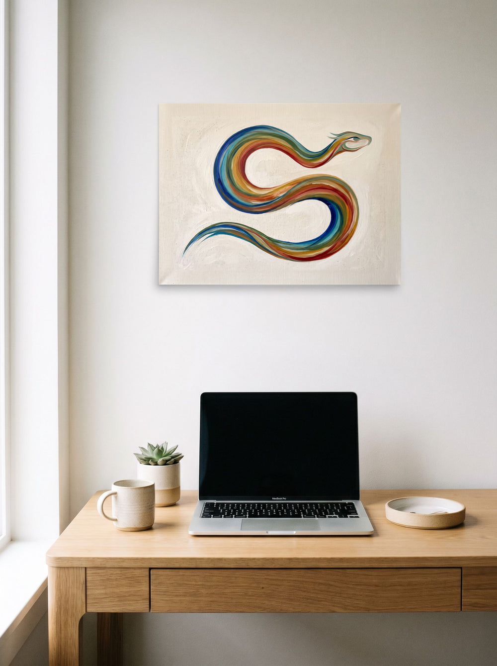 The unframed paper print 'Path of the Rainbow Serpent' displayed over a compact desk setup, shown at 24x18 inch.
