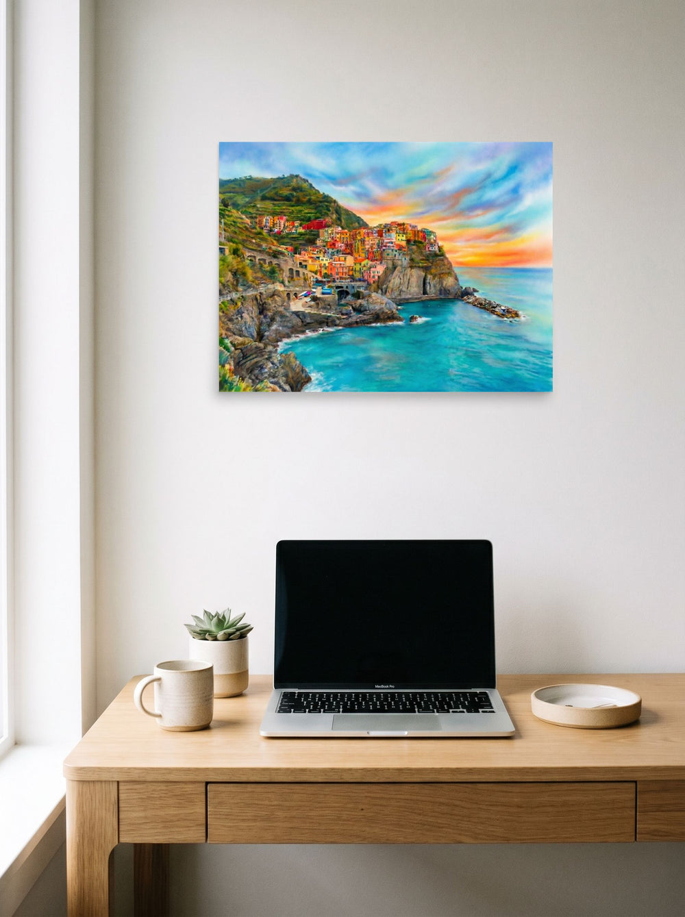 A 24x18 inch unframed paper Realism,Romanticism print of 'Coastal Dreams' hanging above a worktable with a laptop.