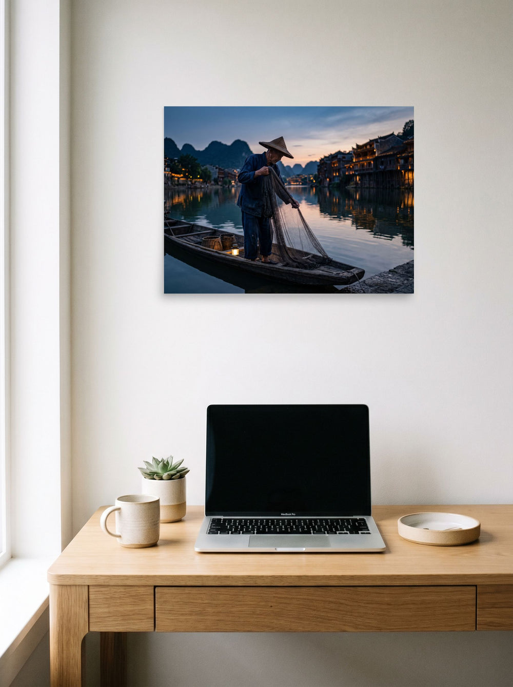 A 24x18 inch unframed paper Art photography print of 'Twilight River' hanging above a worktable with a laptop.