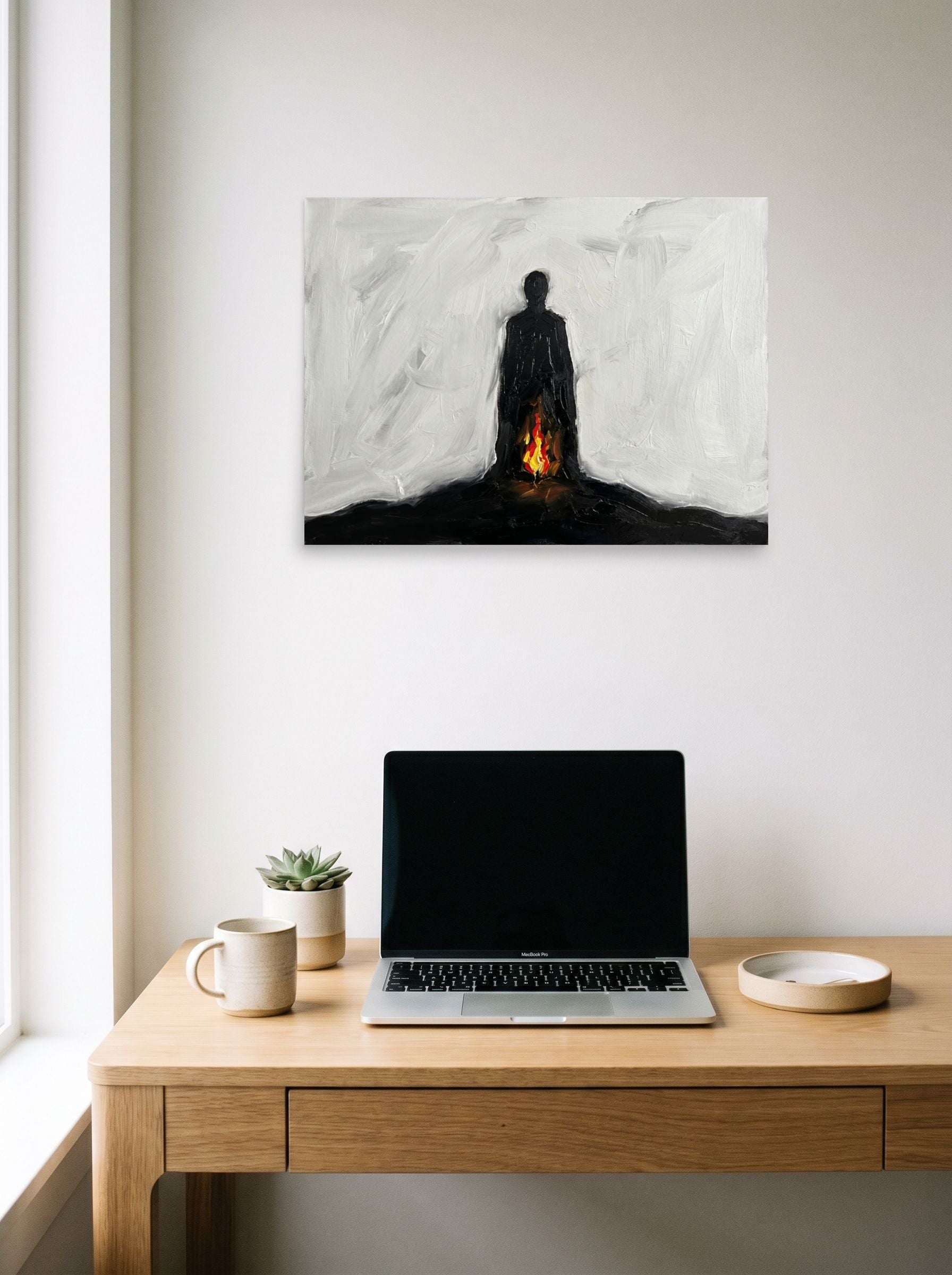 A 24x18 inch unframed paper Minimalism,Expressionism print of 'Inner Flame' hanging above a worktable with a laptop.