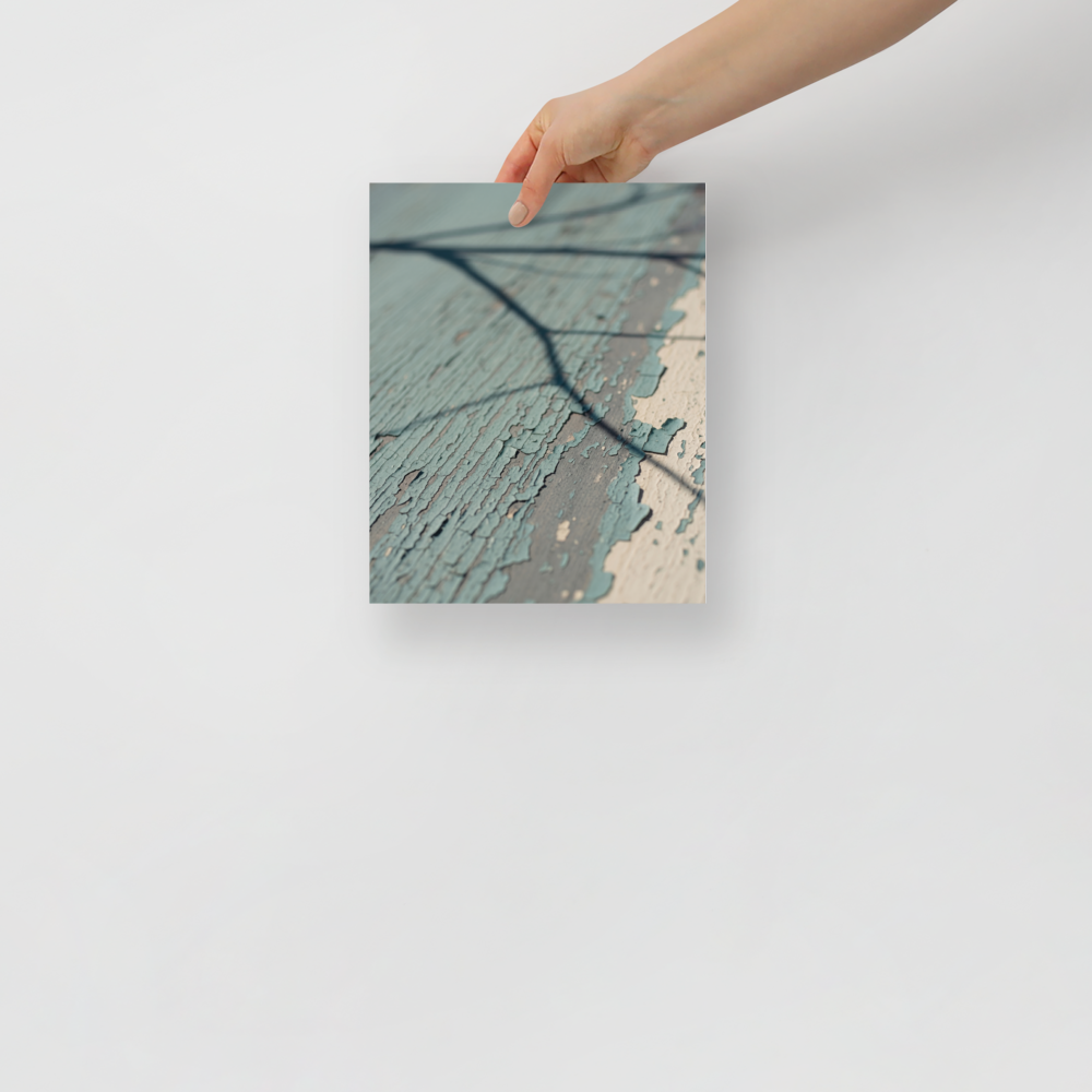 'Fading Blue' — a Art photography print. A close-up photograph of peeling light blue paint on weathered wood with a sharp shadow of a tree branch, suitable for a cozy Sunroom or Bedroom.