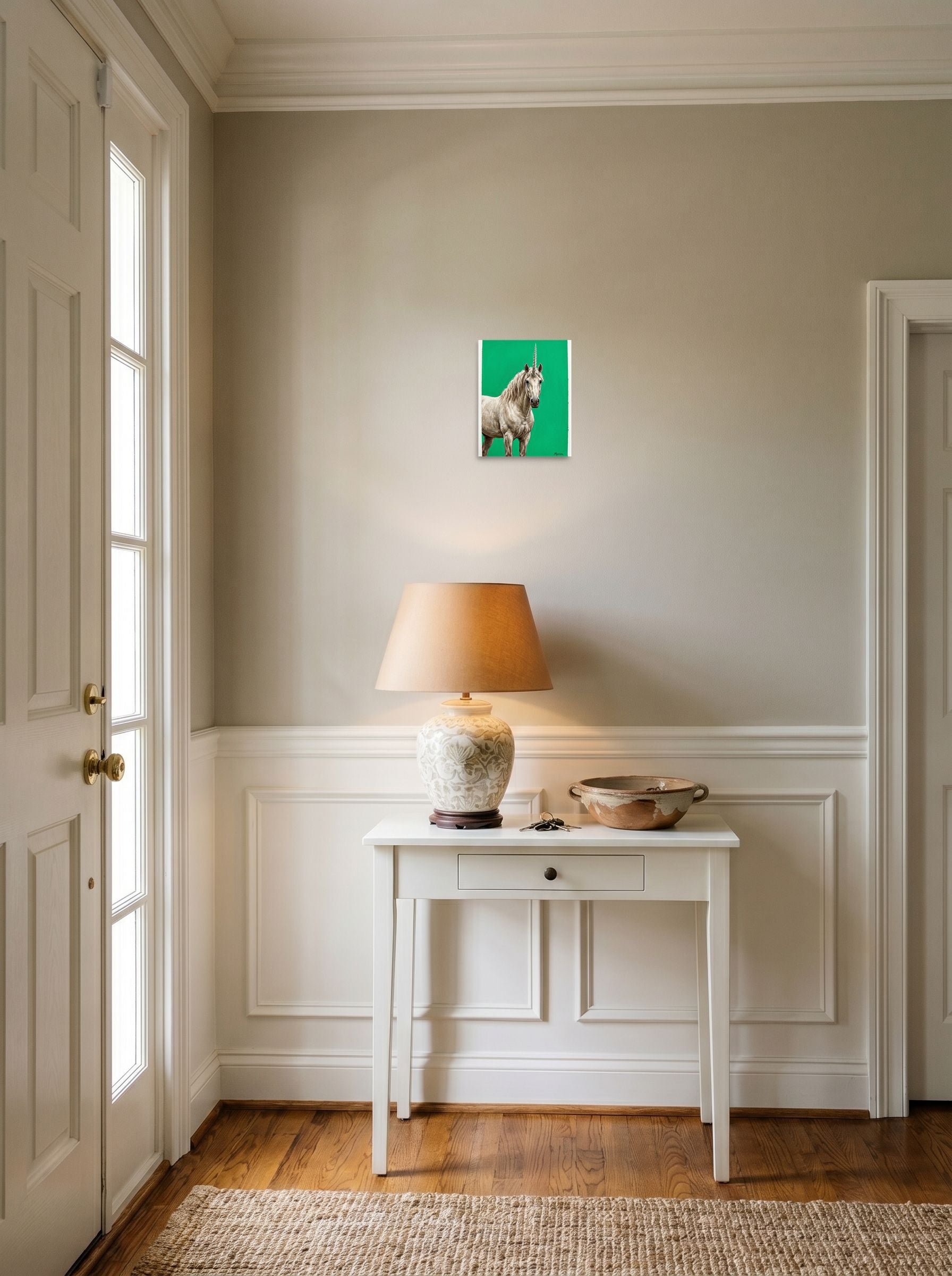 A 8x10 inch unframed paper Realism print of 'The Emerald Unicorn' hanging in an entryway near a console.