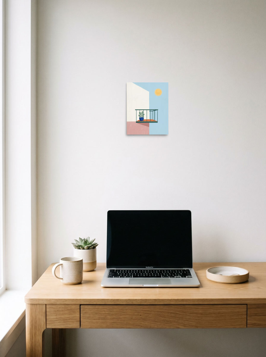 A 8x10 inch unframed paper Minimalism print of 'Sunlit Balcony' hanging above a worktable with a laptop.