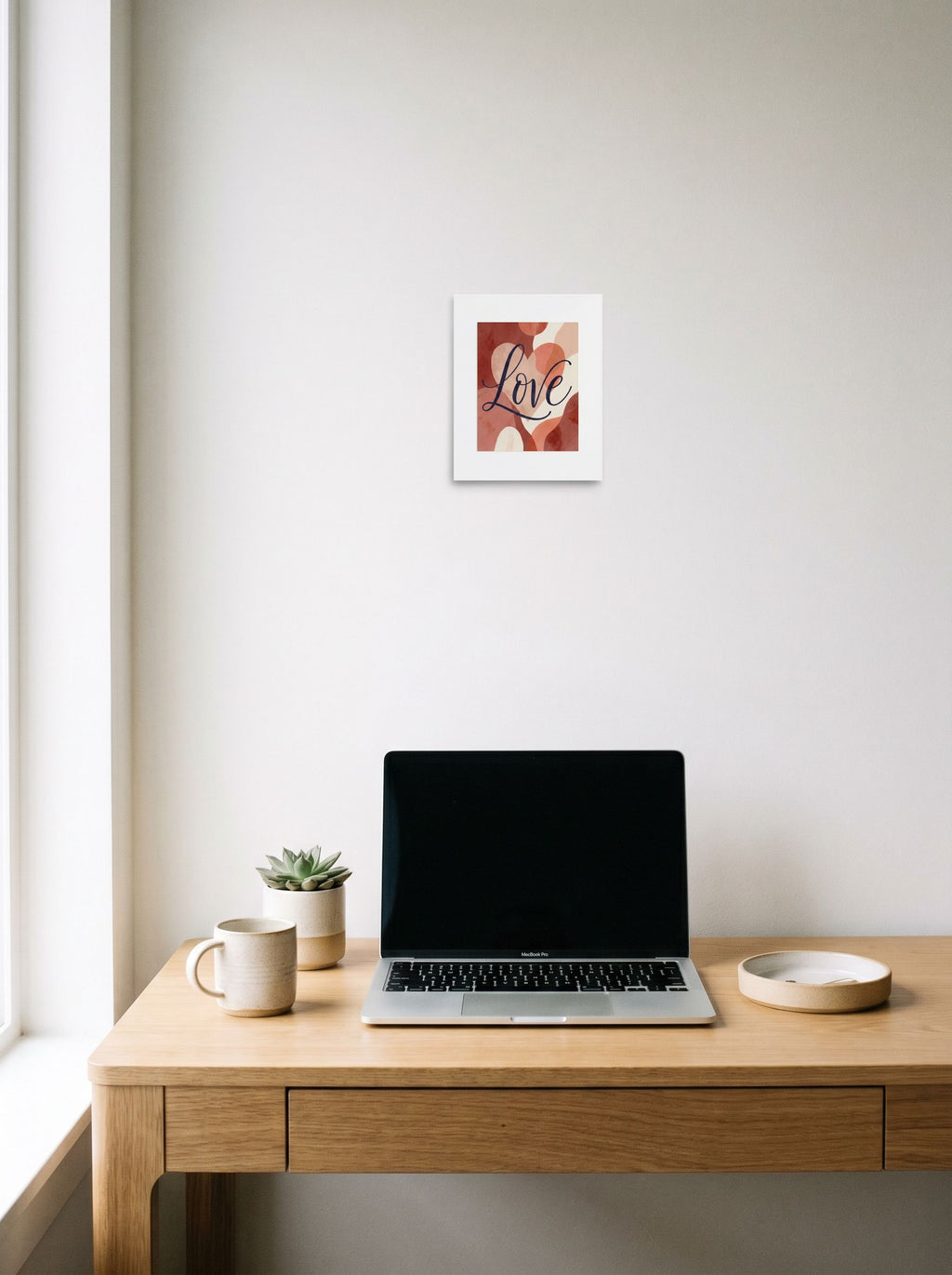 A 8x10 inch unframed paper Abstract art,Minimalism print of 'Painted Affection' hanging above a worktable with a laptop.