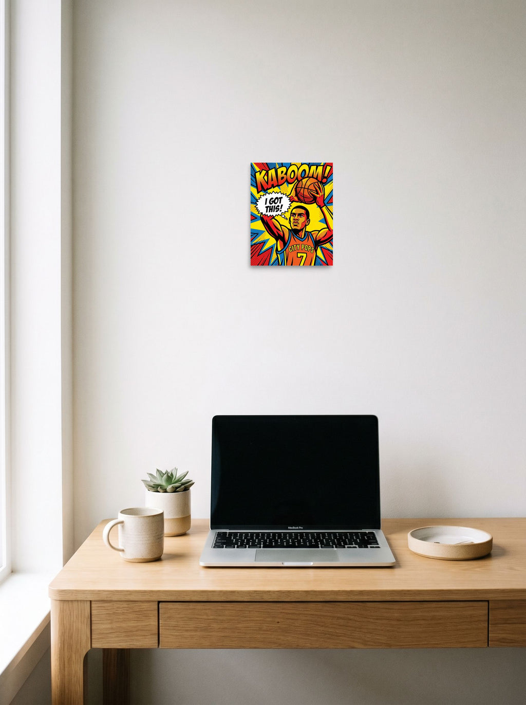 A 8x10 inch unframed paper Pop art print of 'I Got This' hanging above a worktable with a laptop.