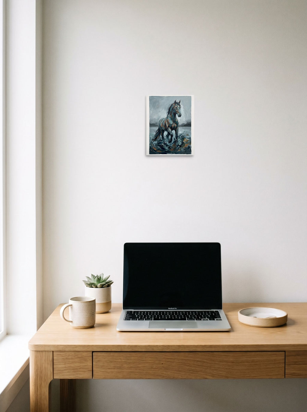 8x10 inch unframed paper print of 'The Water Horse', hanging above a worktable with a laptop.