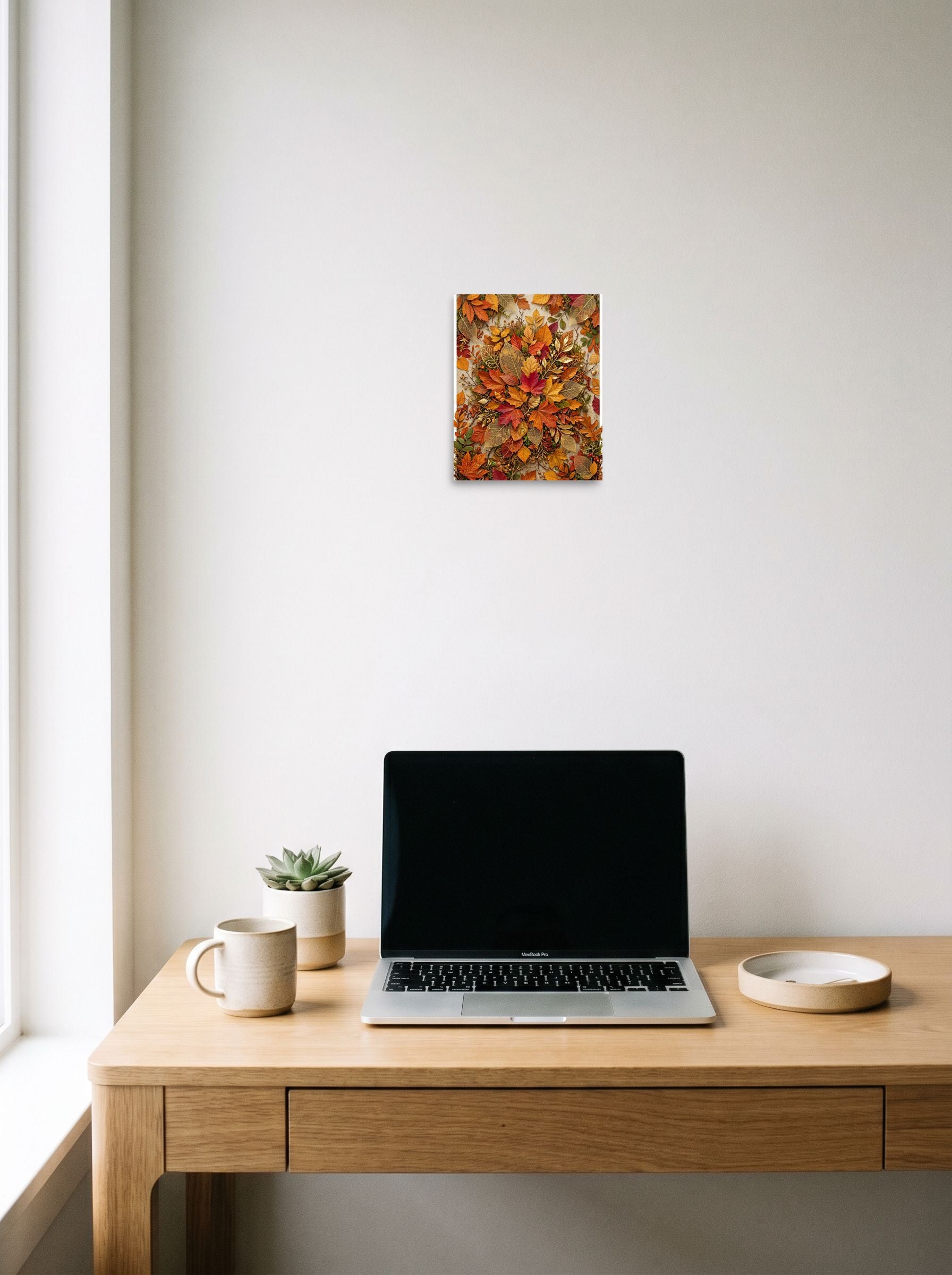 A 8x10 inch unframed paper Assemblage,Realism print of 'Autumn Tapestry' hanging above a worktable with a laptop.