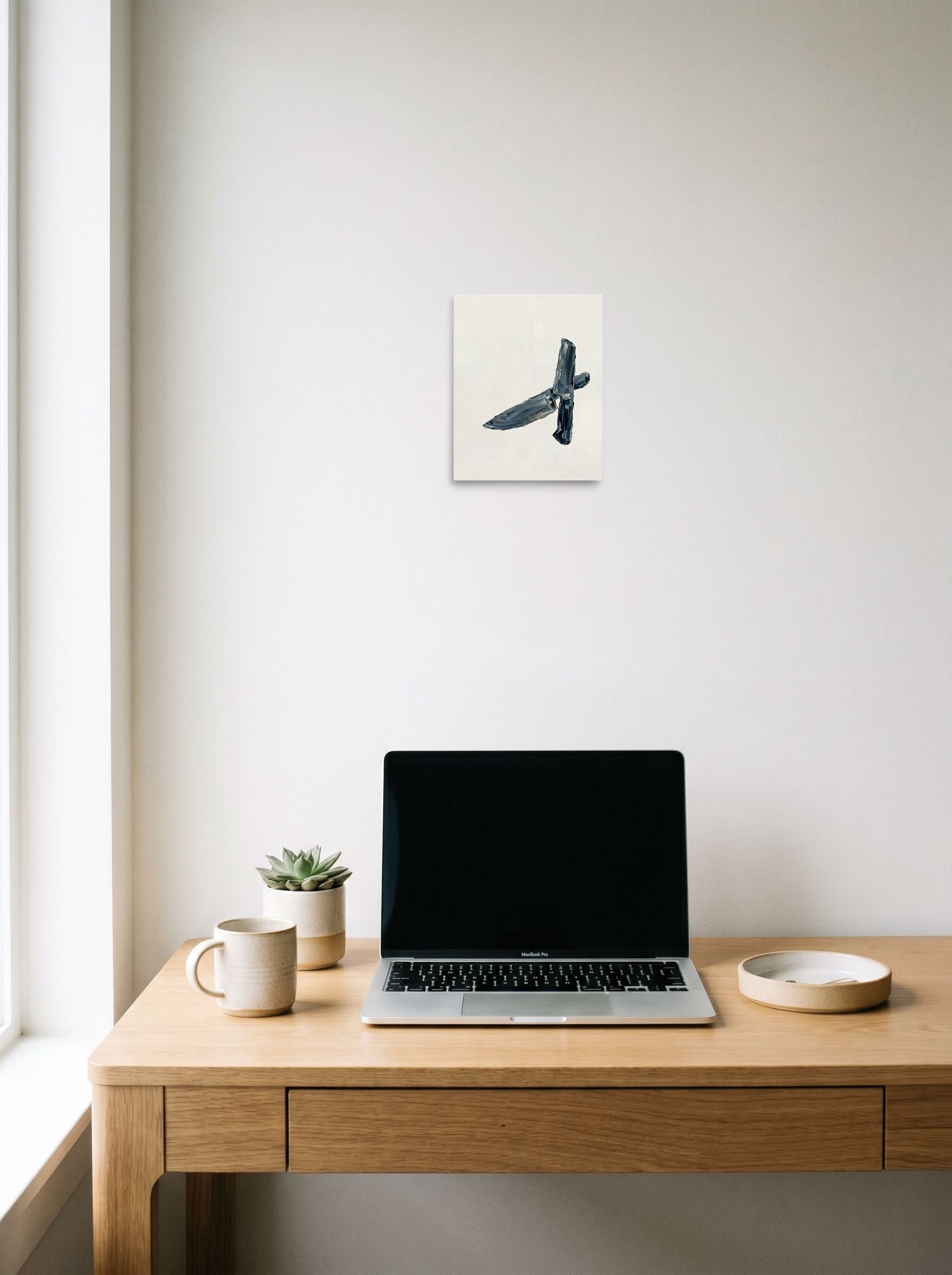 A 8x10 inch unframed paper Minimalism print of 'Culinary Precision' hanging above a worktable with a laptop.