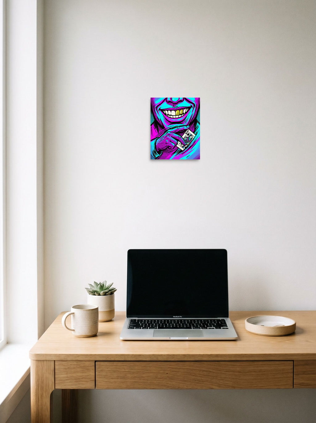 A 8x10 inch unframed paper Pop art print of 'Queen of Spades' hanging above a worktable with a laptop.