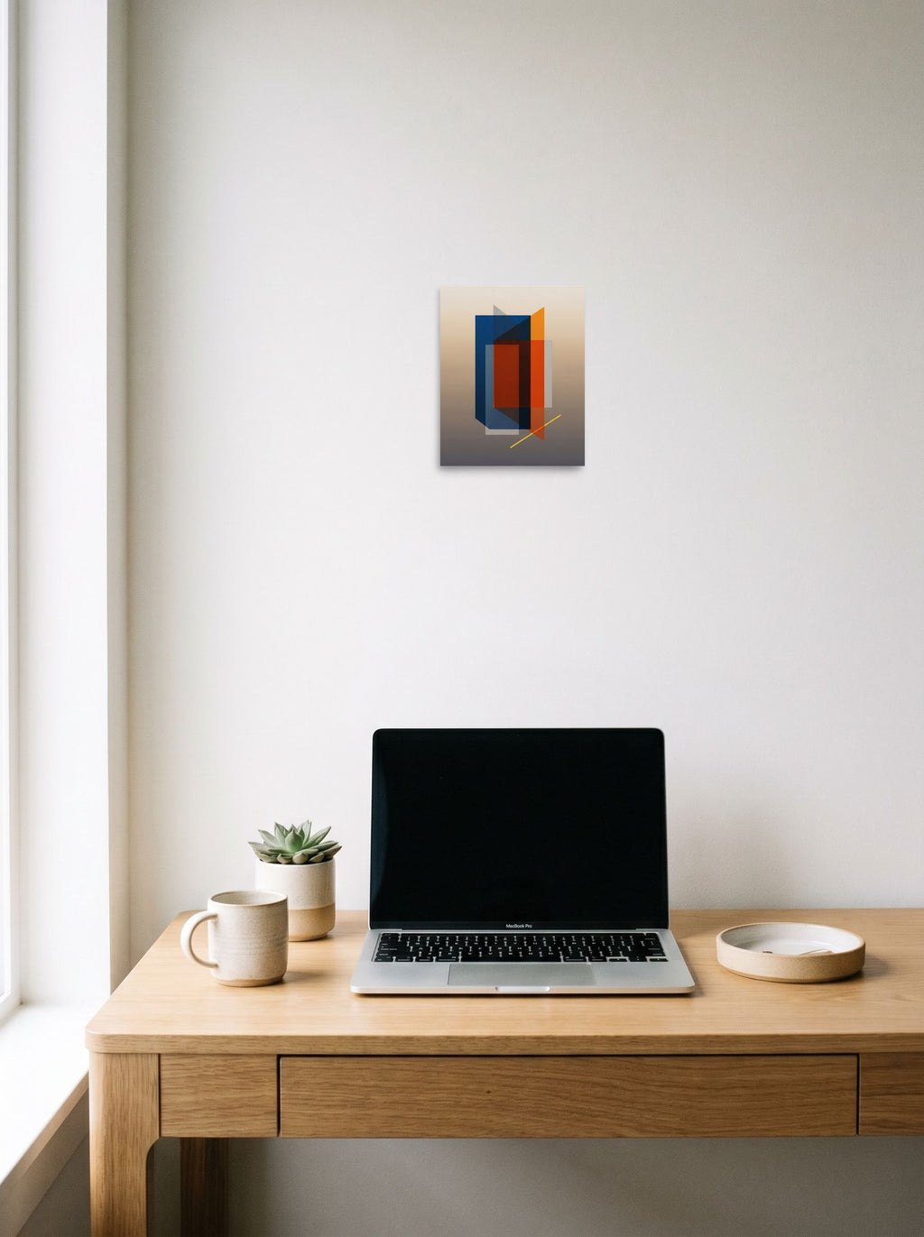 A 8x10 inch unframed paper Minimalism,Geometric abstract art print of 'Translucent Intersections' hanging above a worktable with a laptop.