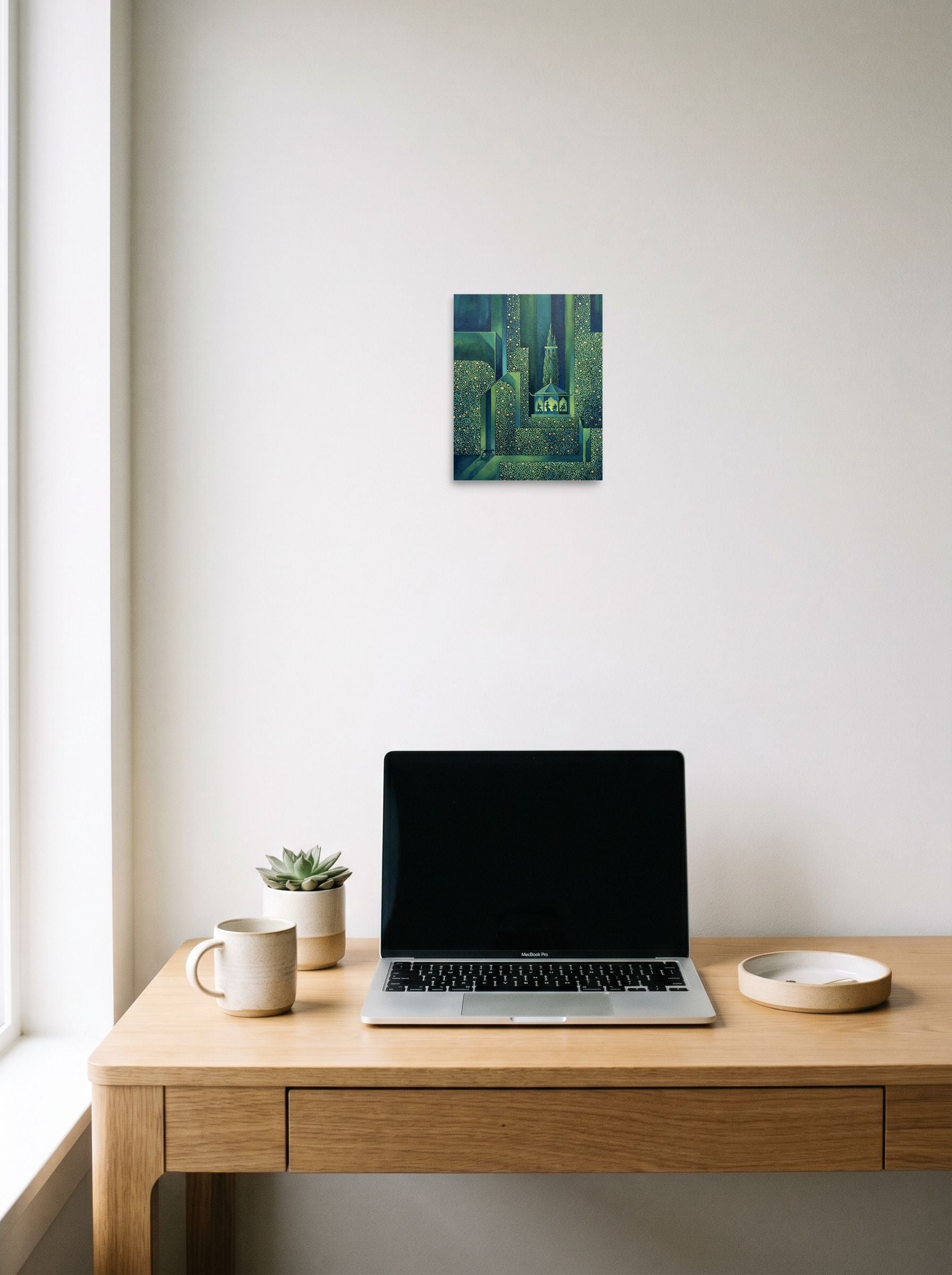 A 8x10 inch unframed paper Art Deco print of 'Starlight Serenade' hanging above a worktable with a laptop.