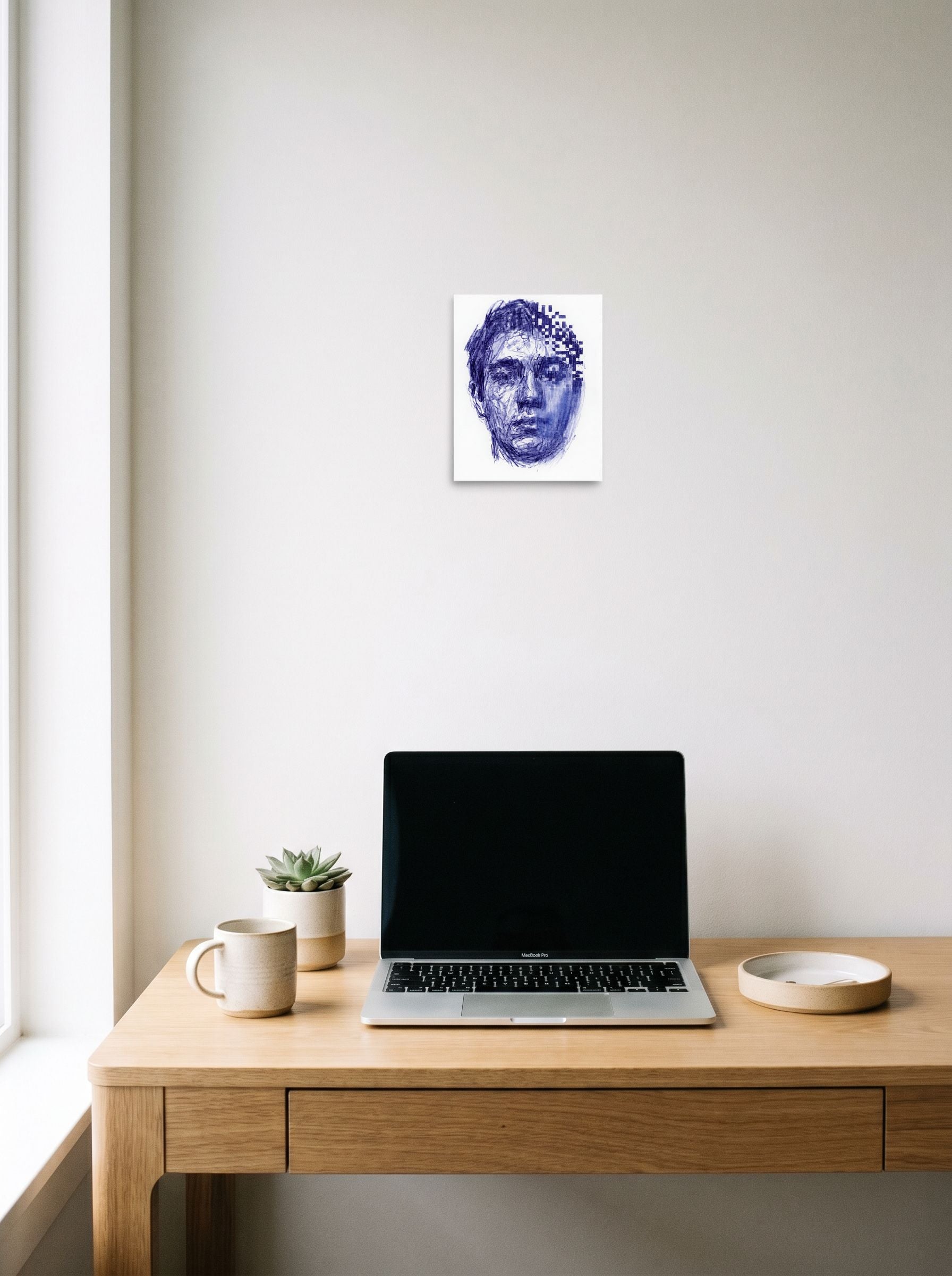 A 8x10 inch unframed paper Glitch art,Surrealism print of 'Digital Dissolution' hanging above a worktable with a laptop.