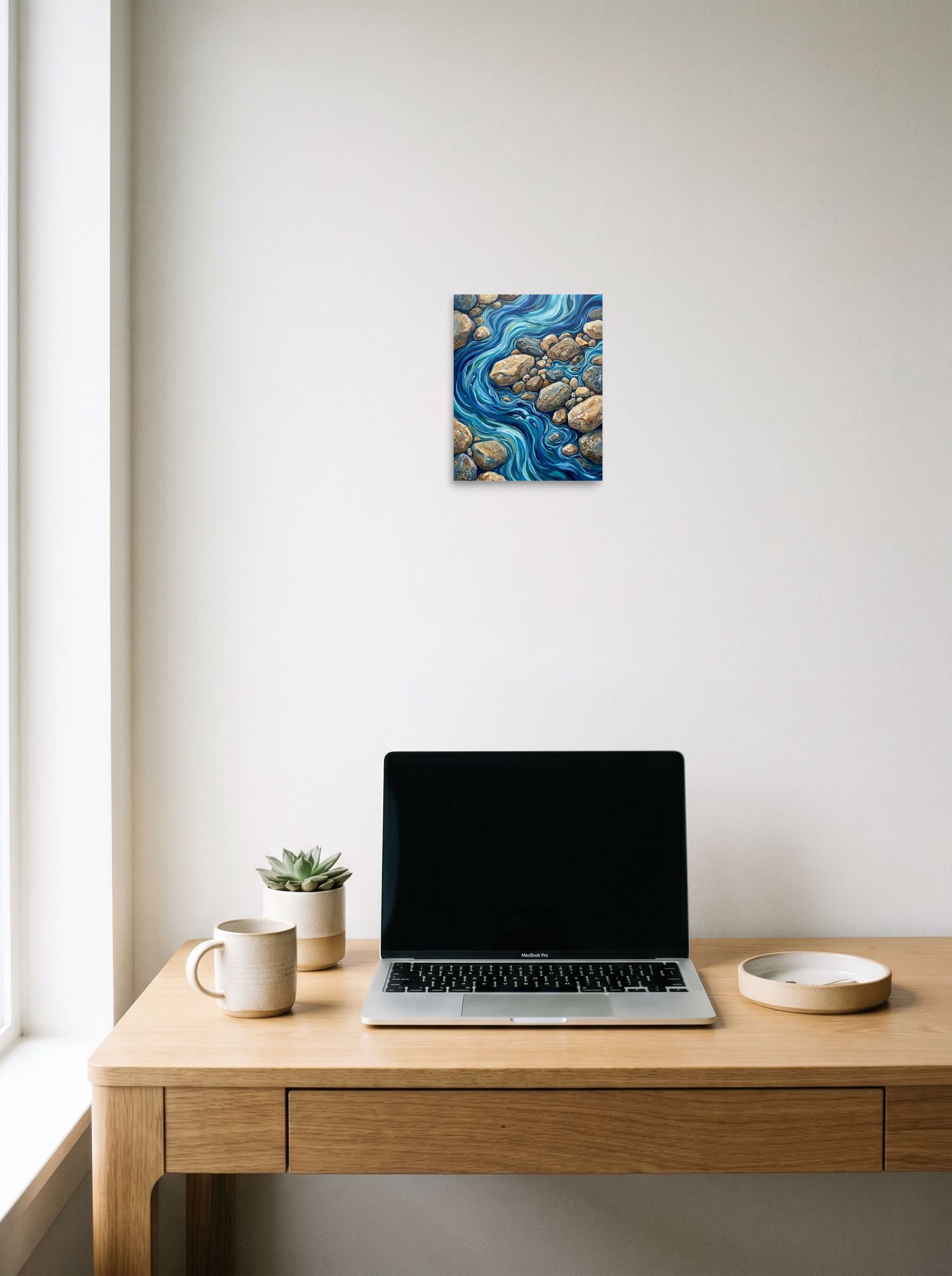 A 8x10 inch unframed paper Abstract expressionism print of 'Riverbed Rhythms' hanging above a worktable with a laptop.