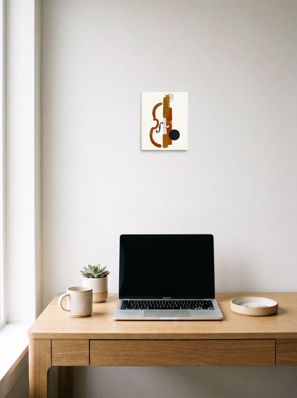 A 8x10 inch unframed paper Minimalism print of 'Symphony in Fragments' hanging above a worktable with a laptop.